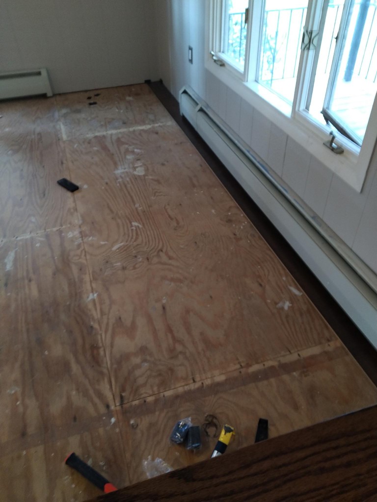 Laminate flooring installation started along a window wall