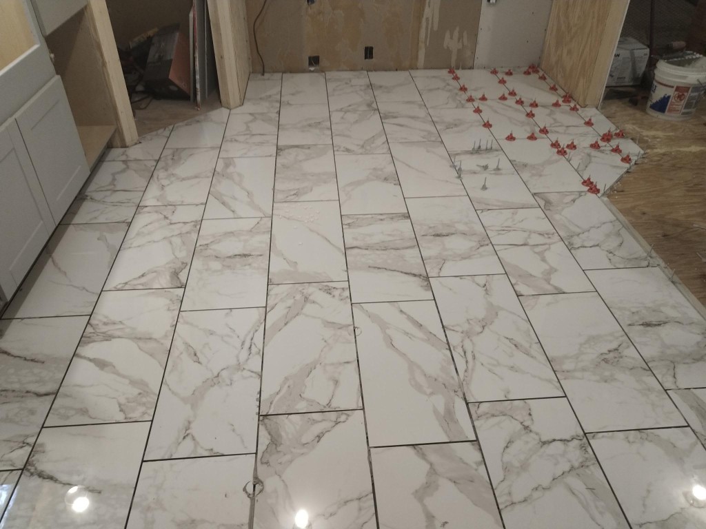 Wide view of kitchen floor tile installation